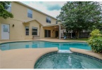 Large pool area with hot tub and shade trees